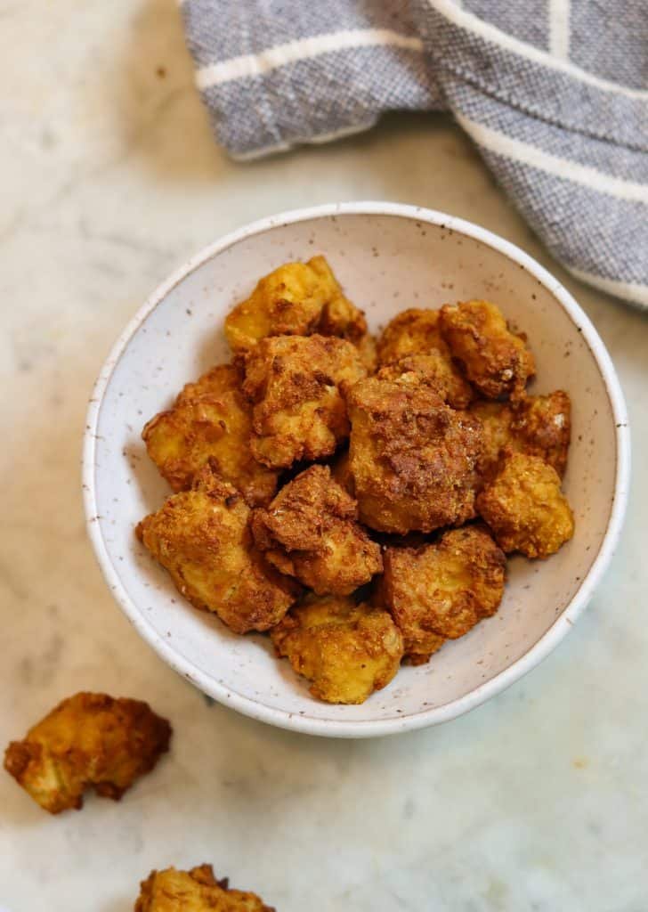 crispy tofu air fried in a little bowl.