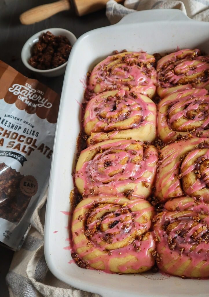 Cinnamon rolls with pink frosting.