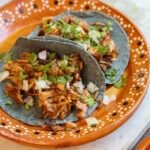 jackfruit tacos on a mexican plate.