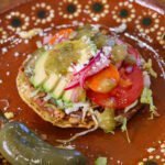 bean tostada on a mexican plate.