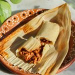 tamales on a mexican plate.