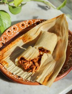 tamales on a mexican plate.