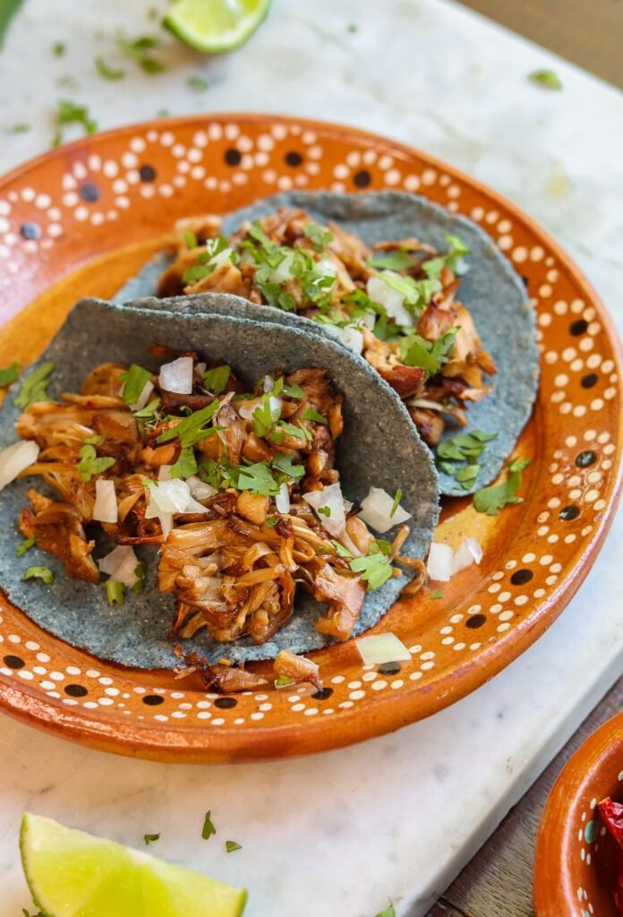 jackfruit carnitas tacos on a mexican plate.