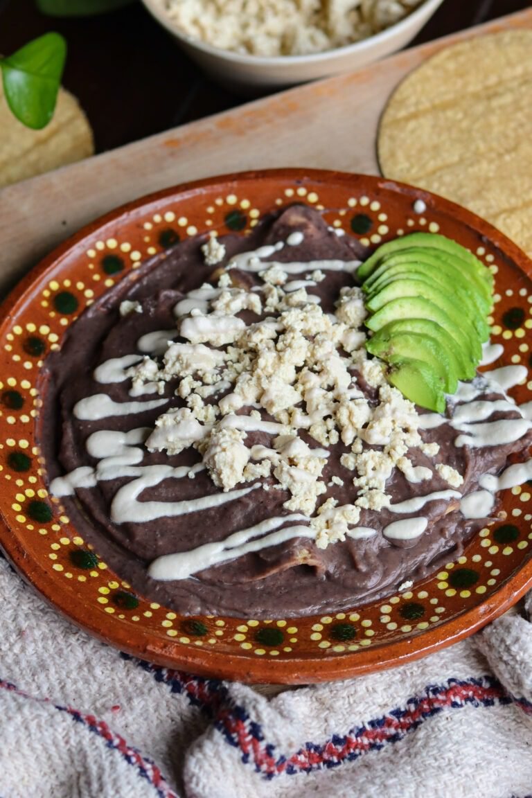 enfrijoladas on a Mexican plate