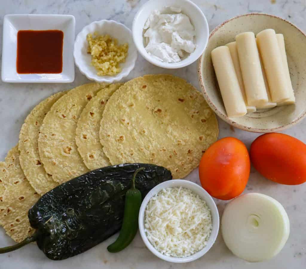 ingredients for tacos gobernador on a white surface.