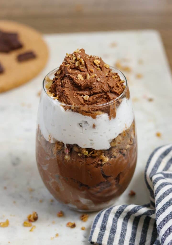 chocolate mousse in a glass cup with whipped cream.