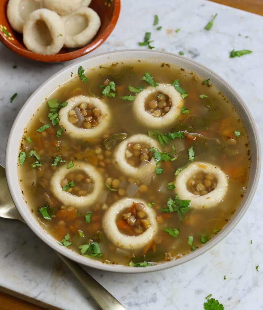 lentil soup with mexican dumplings in a bowl.