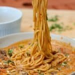 peanut ramen noodles in a white bowl.