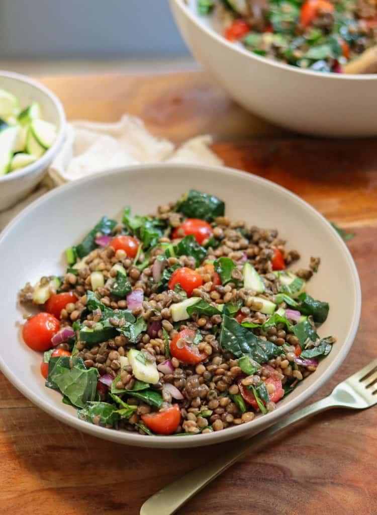 a plate of lentil kale salad in a bowl.