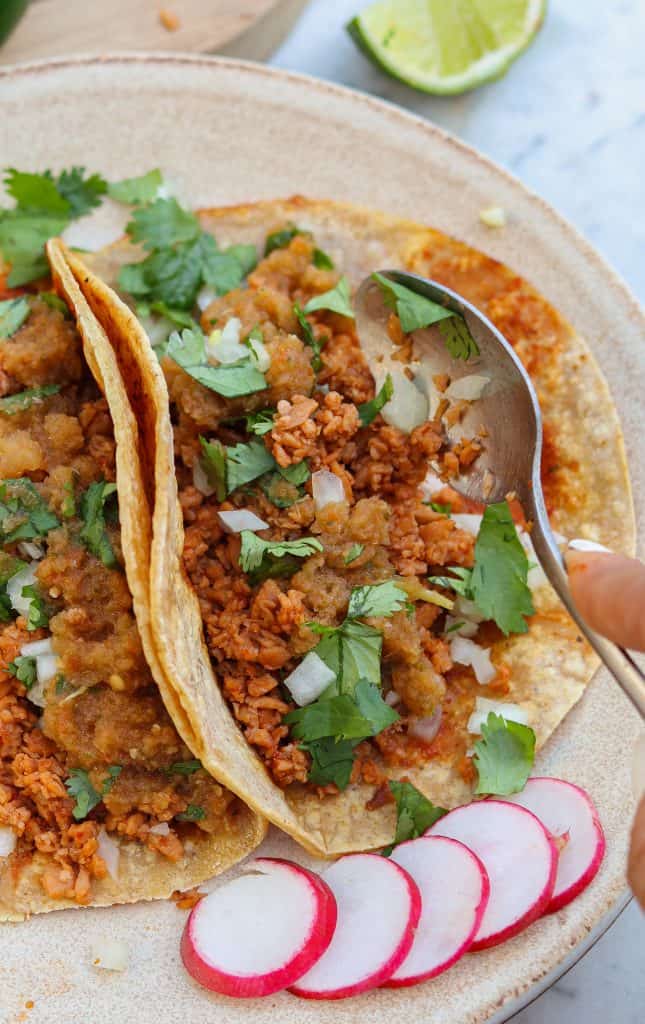 vegan street tacos or vegan tacos al pastor on a plate with radishes.