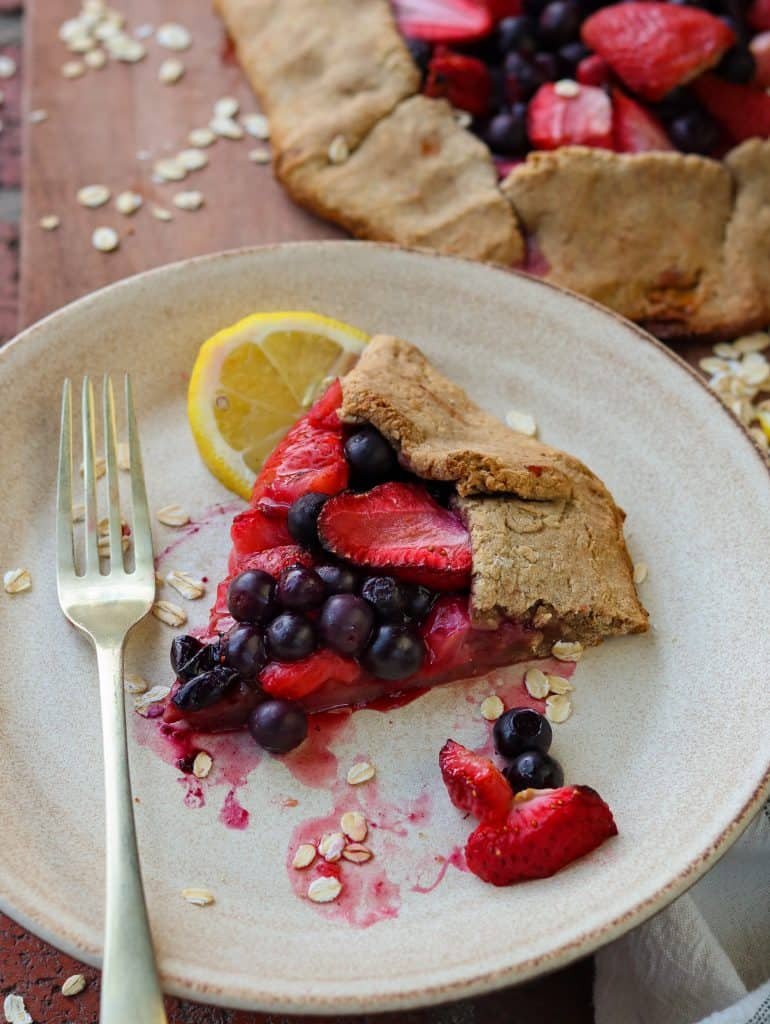 a slice of berry galette on a beige plate