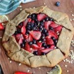 berry galette on a wooden cutting board.
