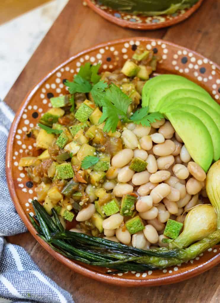 beans and zucchini mexican-style in a plate.