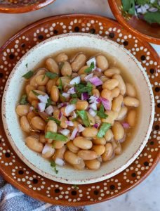 frijoles de la olla or homemade beans in a mexican bowl.