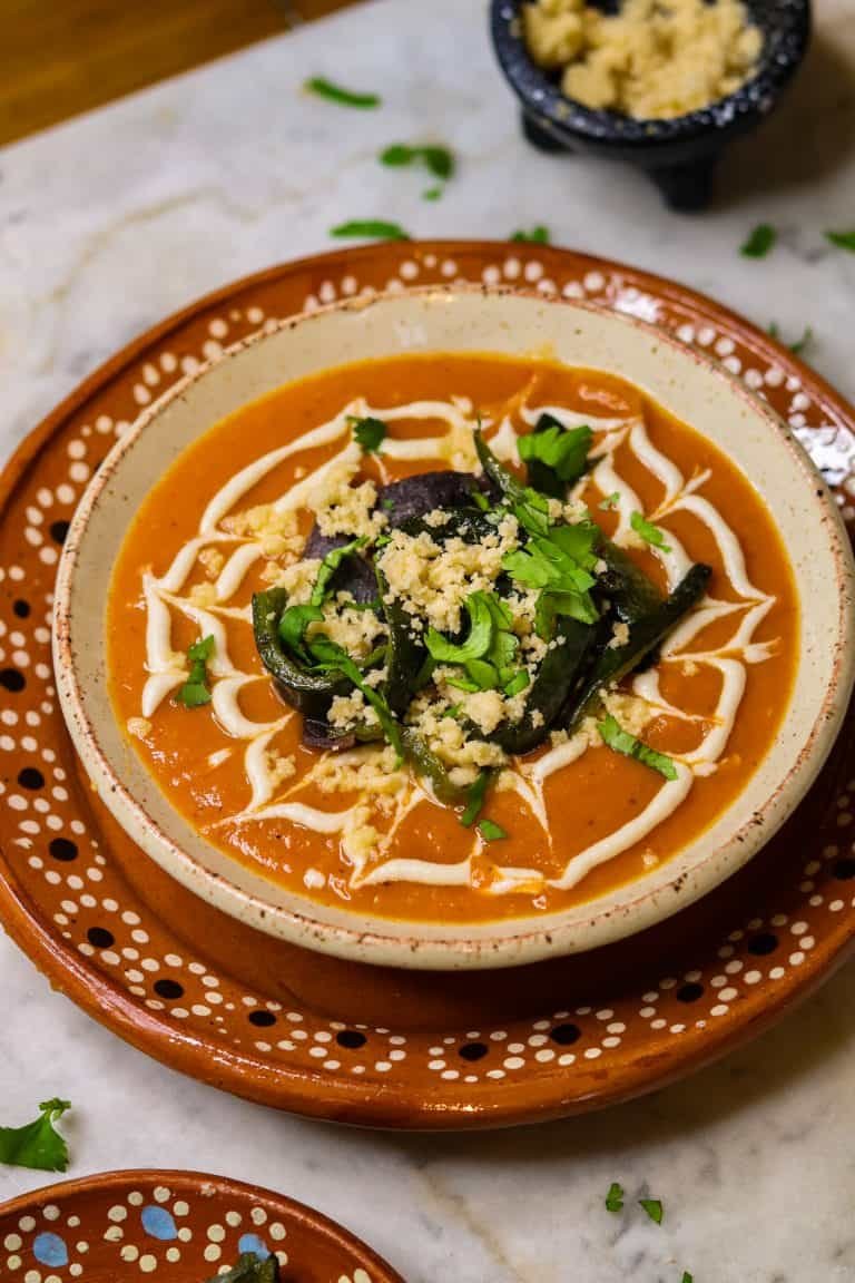 sopa tarasca in a mexican bowl with toppings.