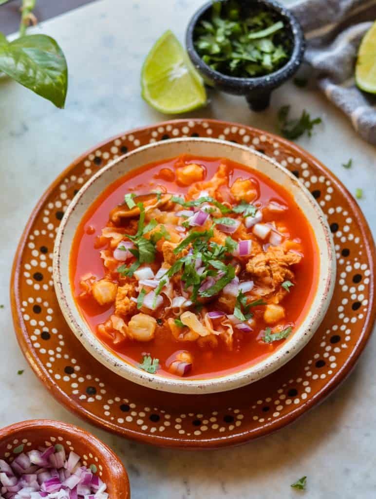 vegan menudo with cilantro and onion on top.