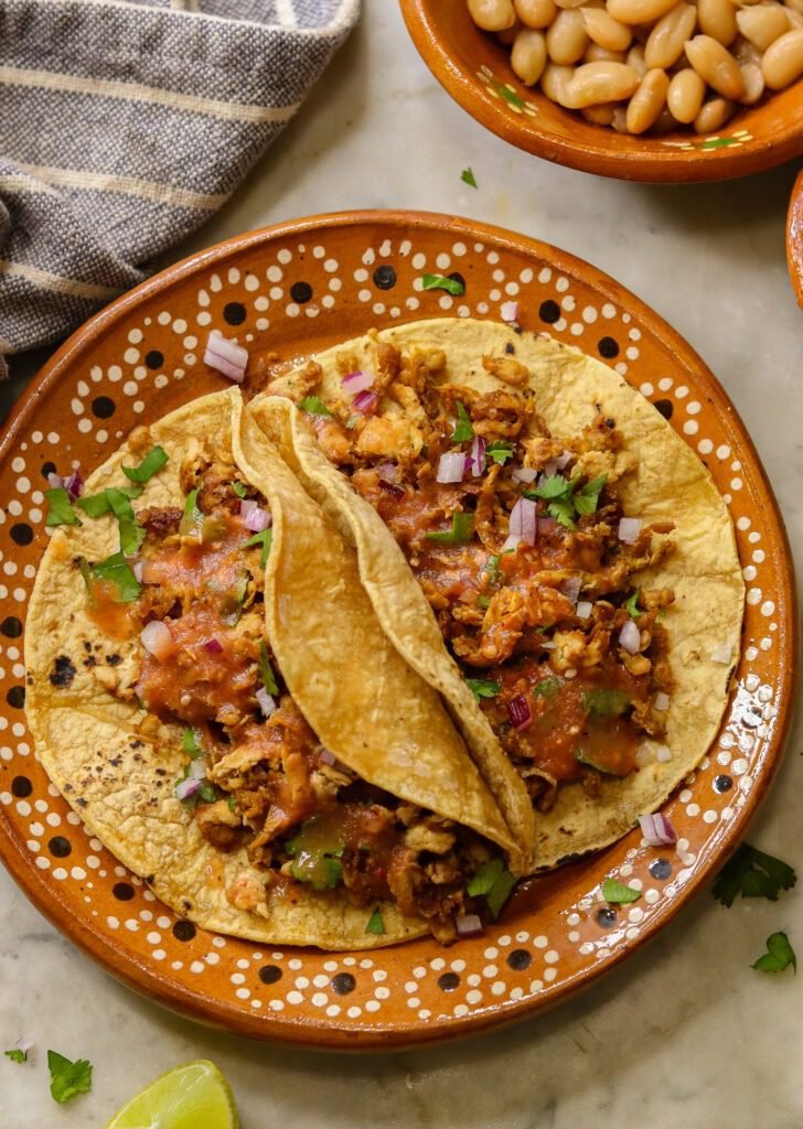 Shredded Tofu Tacos on a mexican plate.