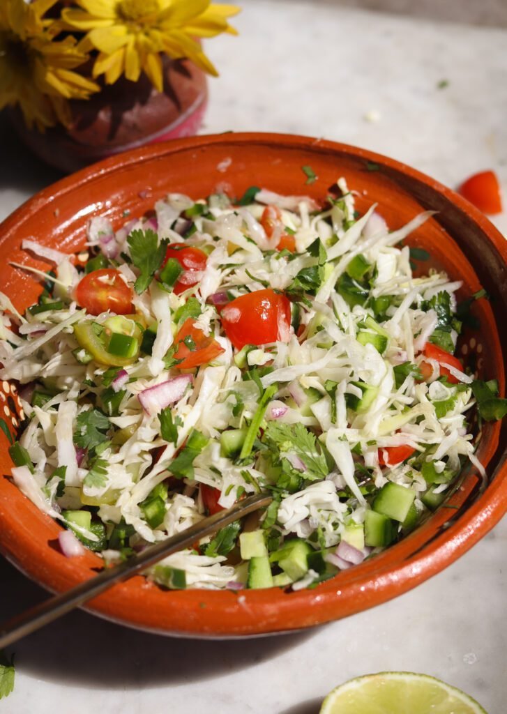 Mexican cabbage slaw in a mexican bowl.