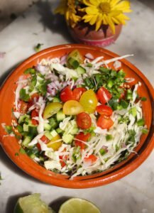 healthy cabbage salsa in a ceramic bowl.