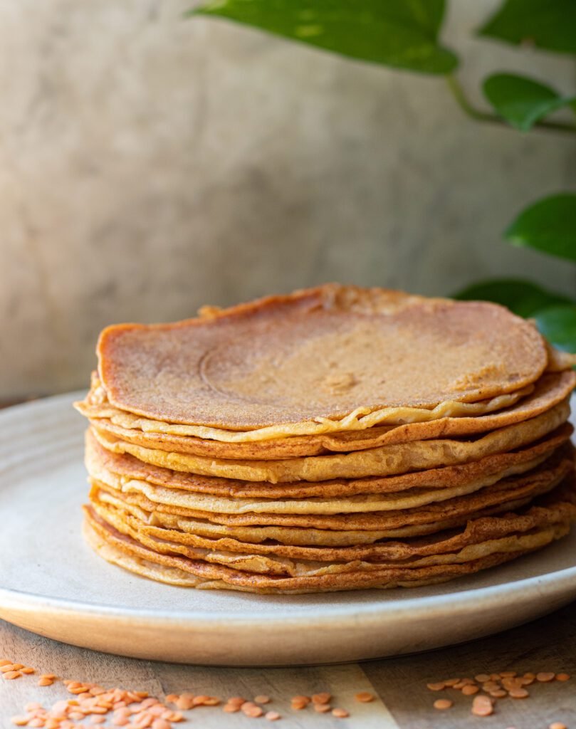 lentil wraps stacked on a plate.