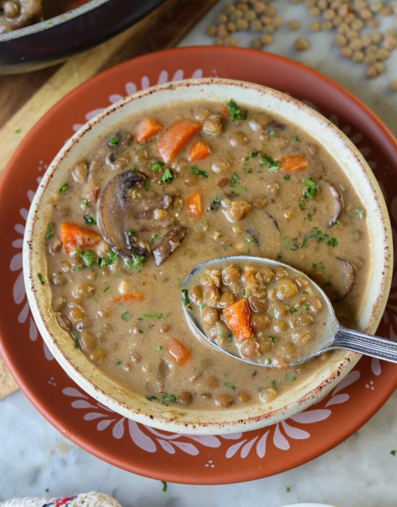 creamy lentil soup in a bowl with mushrooms.