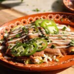 enfrijoladas recipe on a mexican plate.