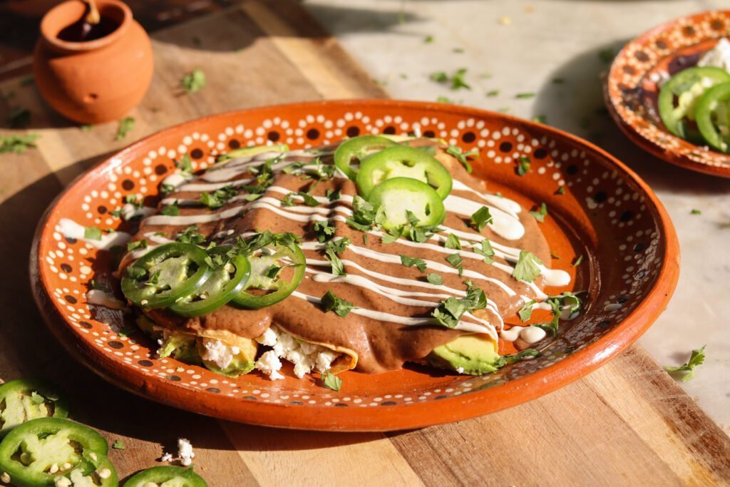 enfrijoladas recipe  on a mexican plate.