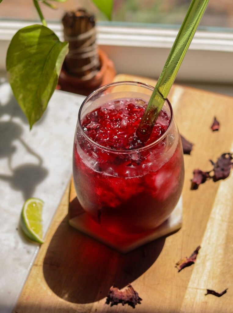 agua de jamaica recipe in a glass with a straw.