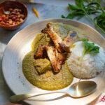 mole verde on a plate with rice and mushroooms.