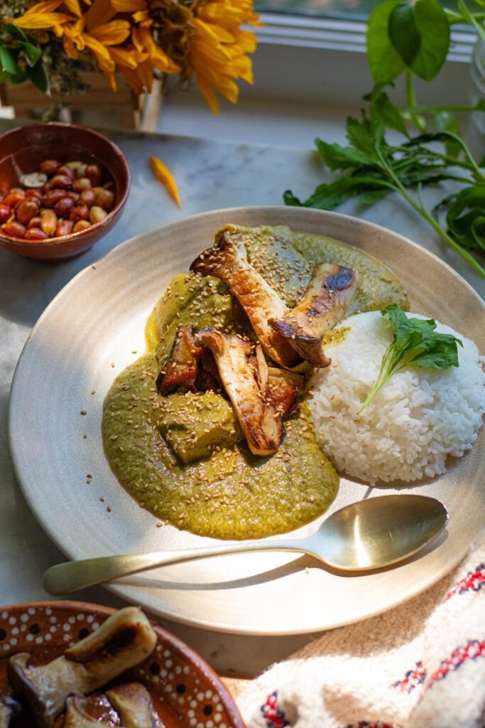 mole verde on a plate with rice and mushroooms.