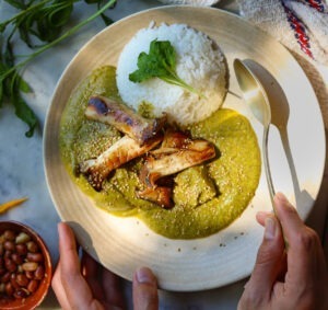 mole verde on a plate with rice.