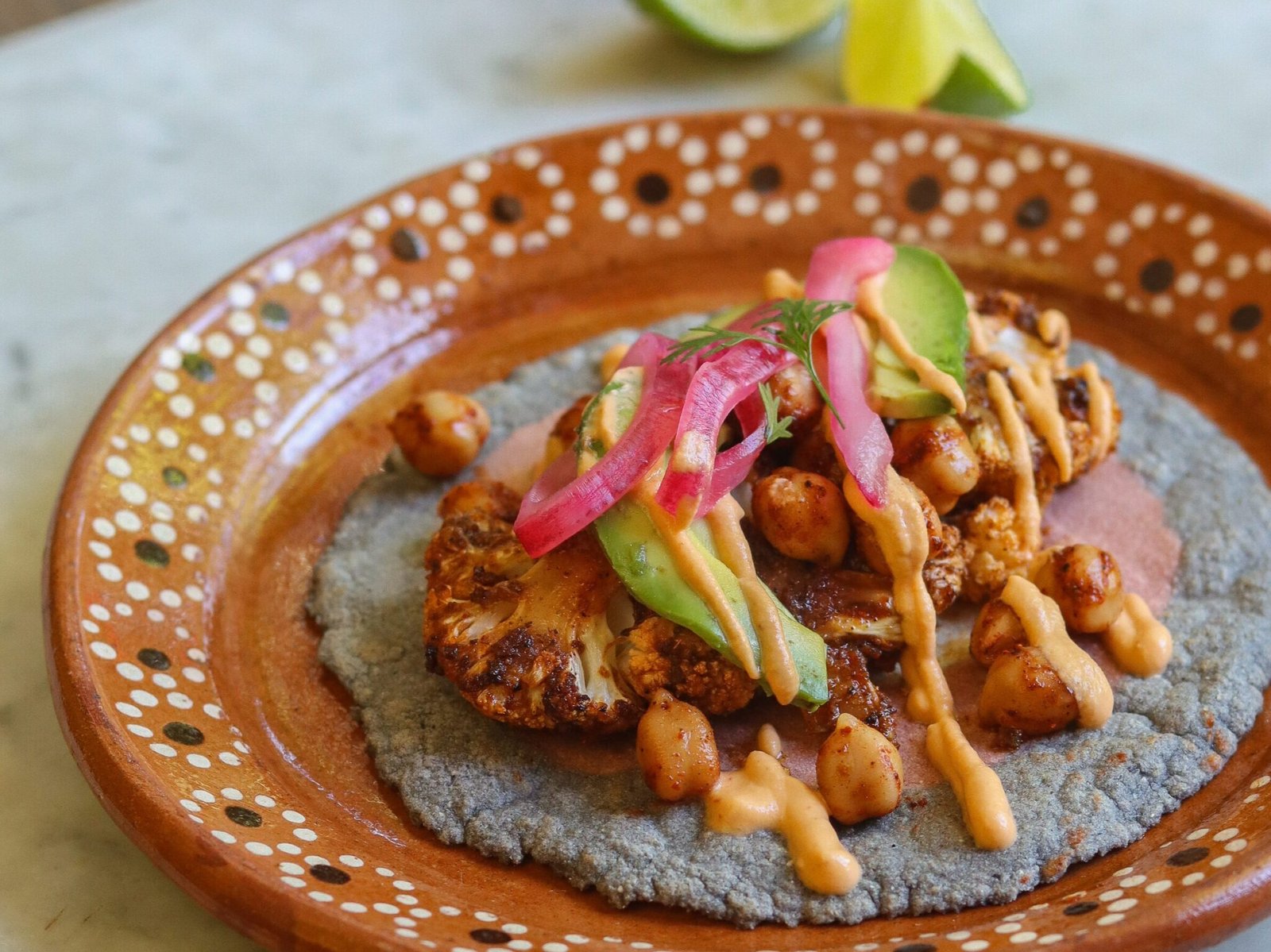 vegan cauliflower taco on a mexican plate.