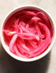 pickled red onion in a small bowl.