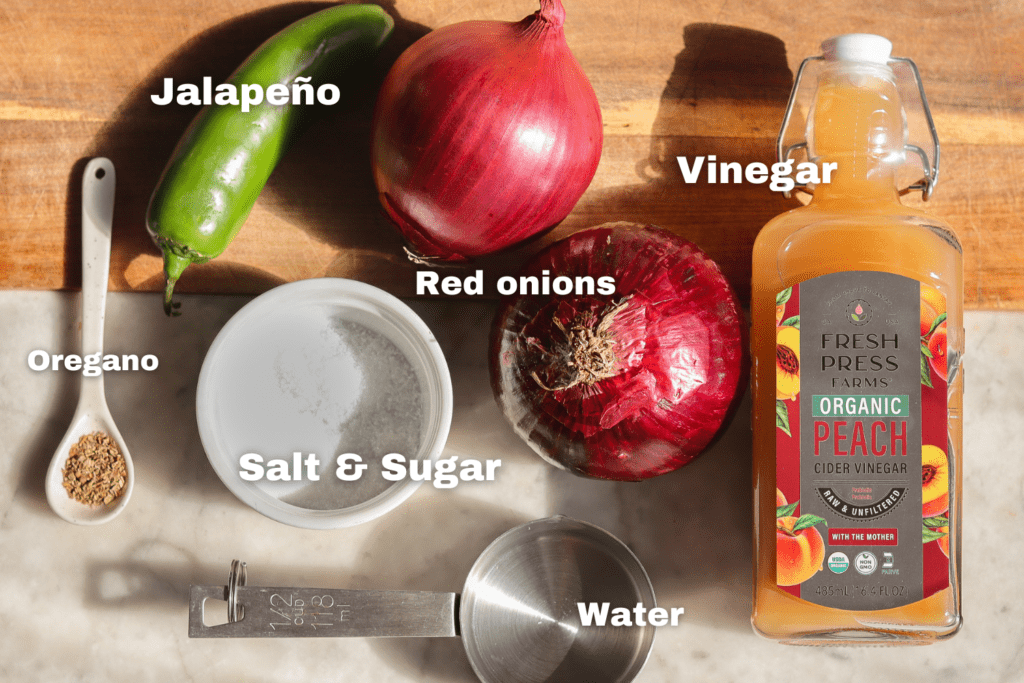 mexican pickled onions ingredients on a cutting board.