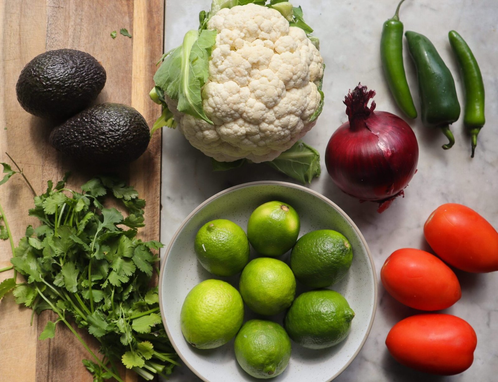 cauliflower ceviche ingredients on a cutting board.