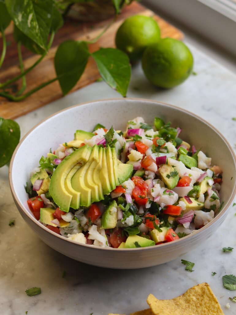 delicious ceviche in a bowl with avocado on top.