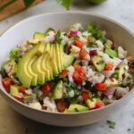 delicious ceviche in a bowl with avocado on top.