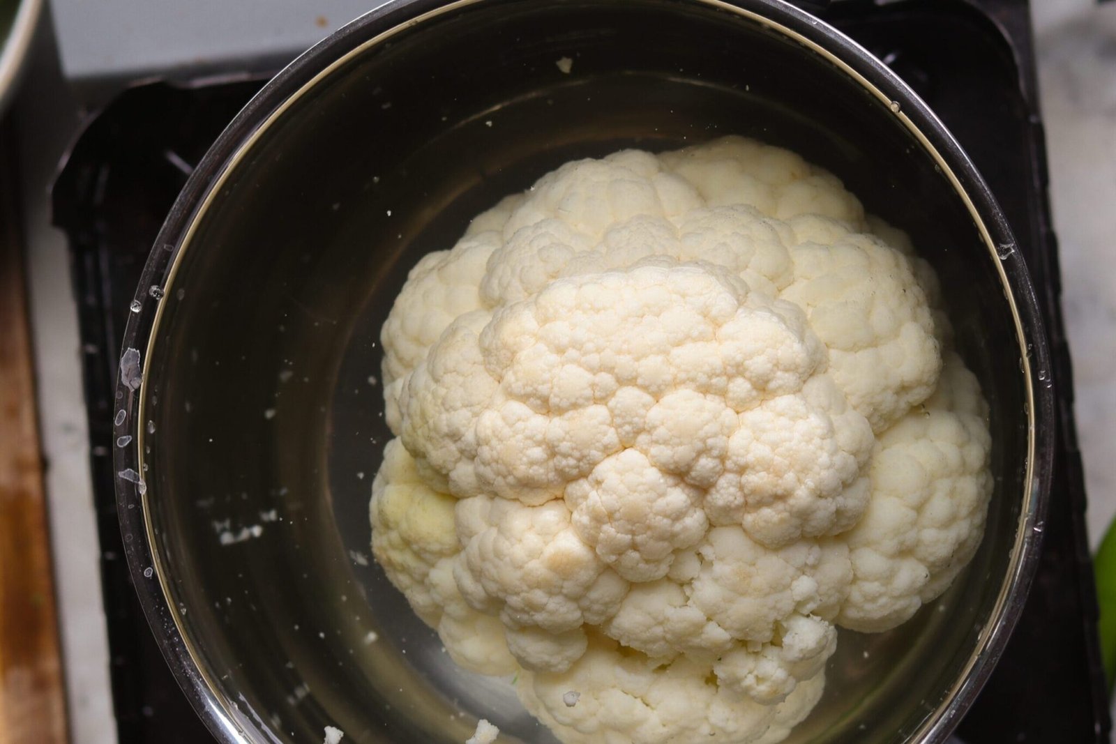 cauliflower simmering in a pot.