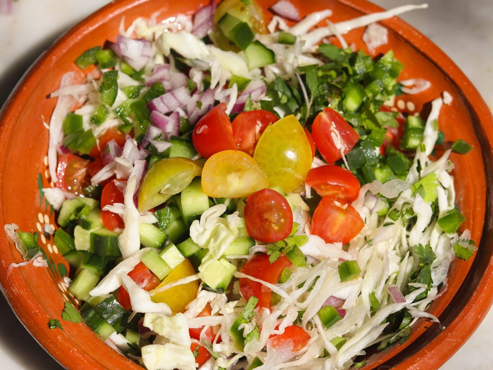 healthy cabbage salsa in a ceramic bowl.