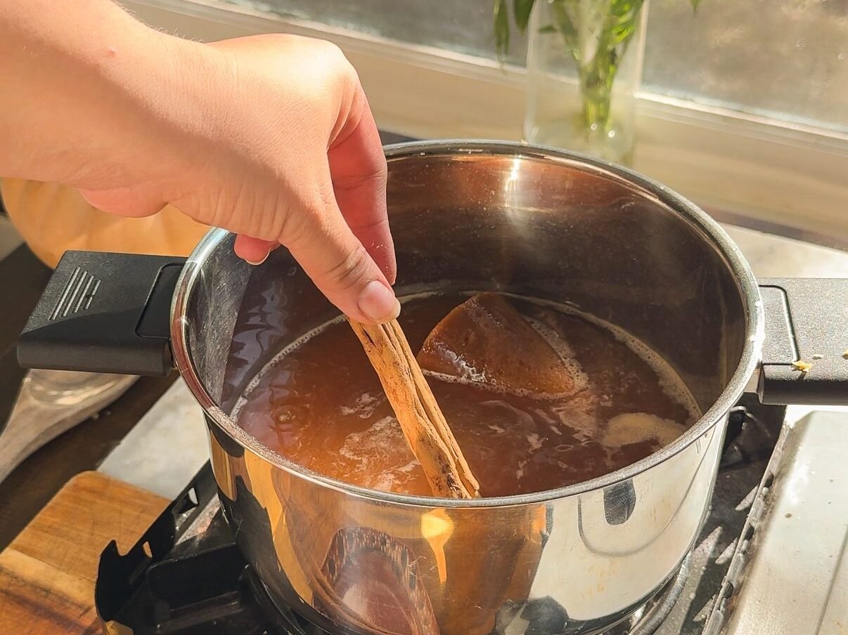simmering the water with cinnamon and sugar.
