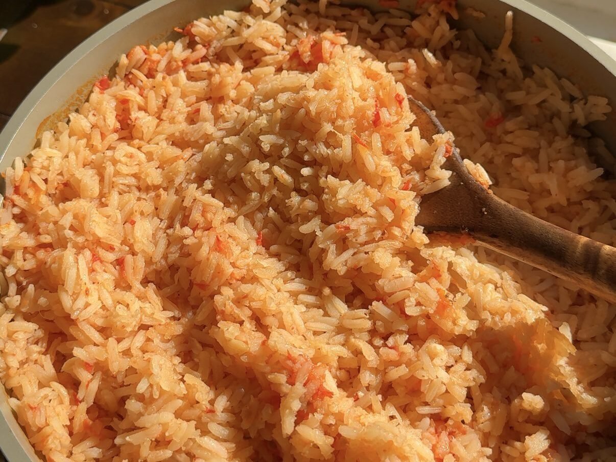 fluffing the rice in a pan.